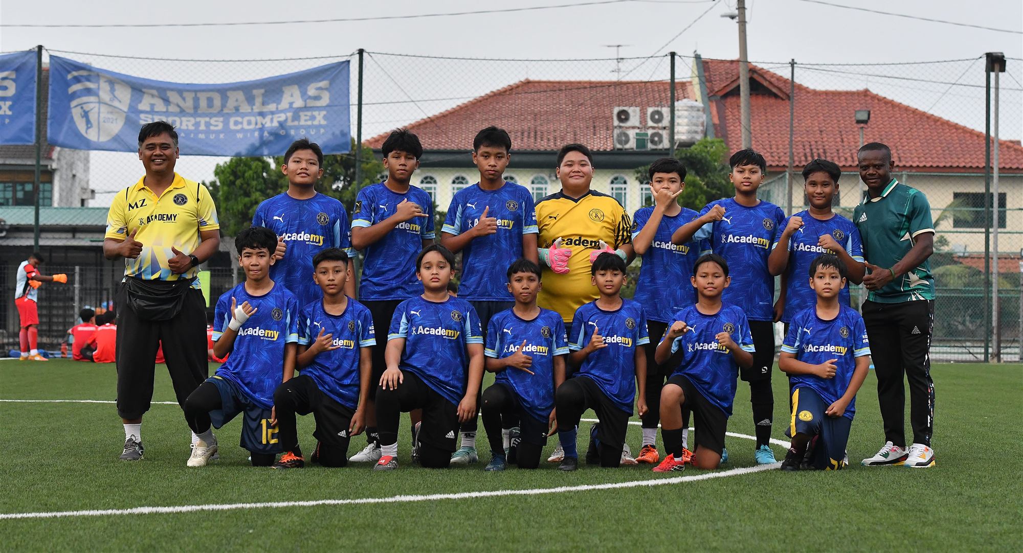JK Football Academy players and coaches on the pitch